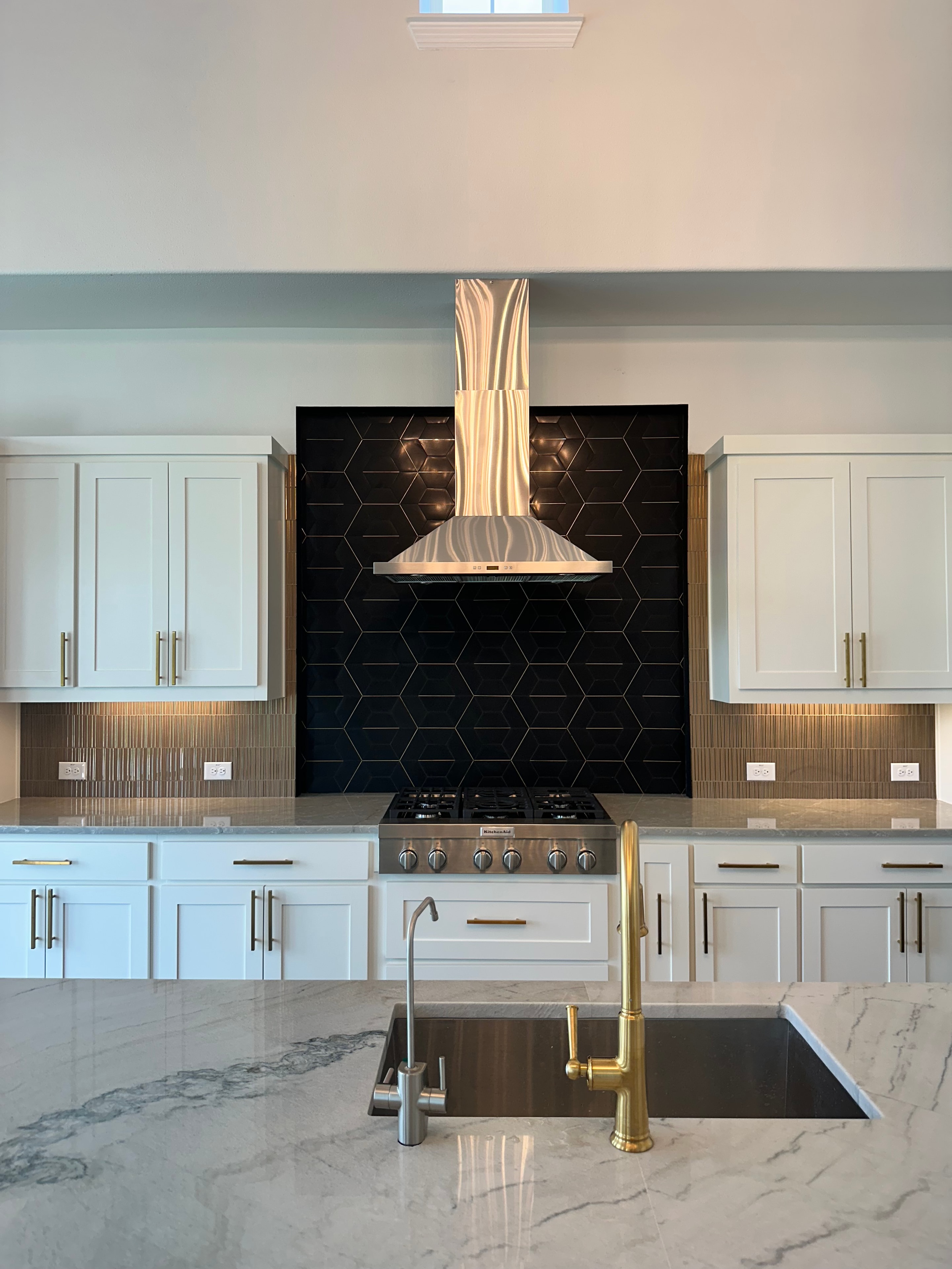 Plano Residence — kitchen detail with brass faucet and marble countertop